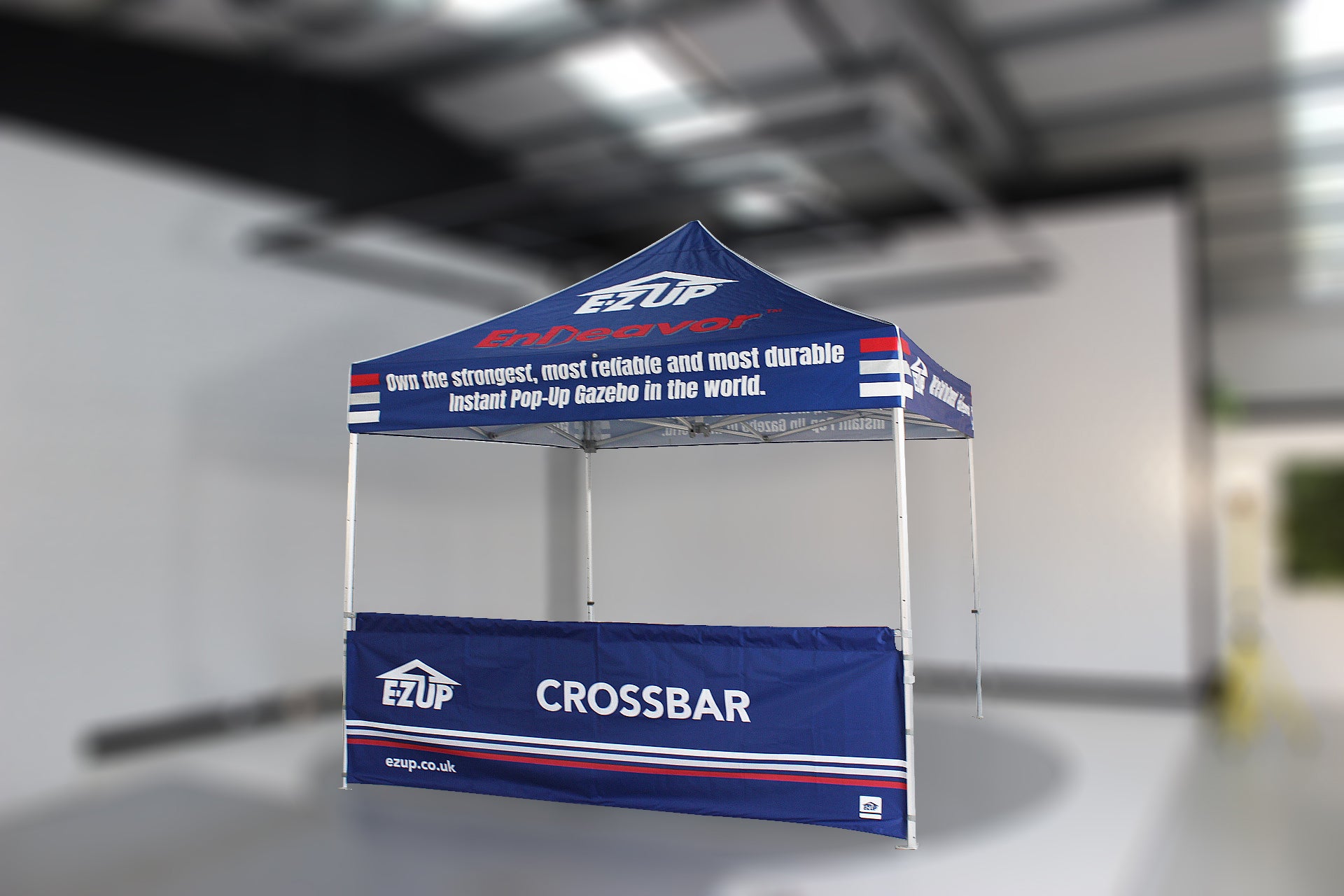 Blue EZUP tent with branding in an indoor setting