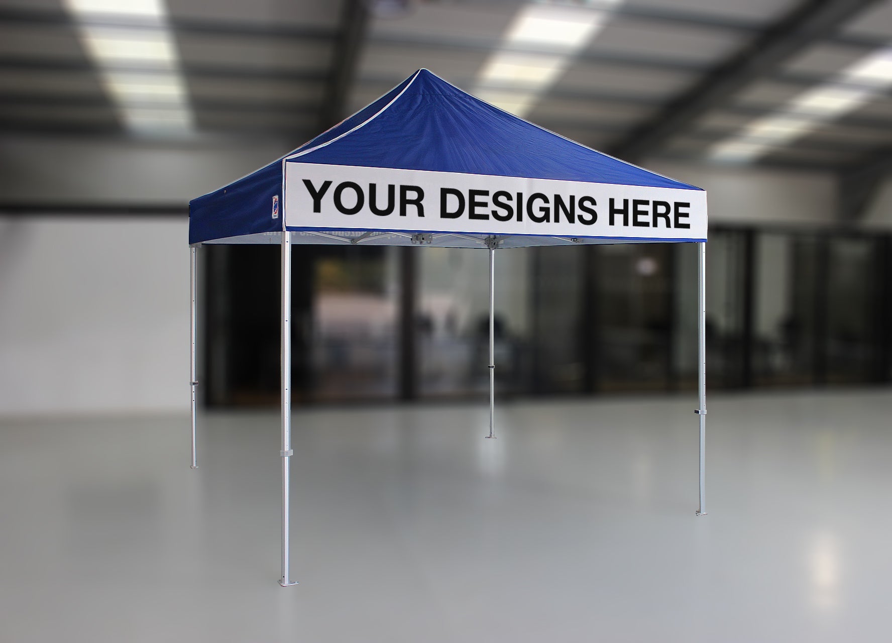 Blue and white tent with customizable text in a warehouse setting